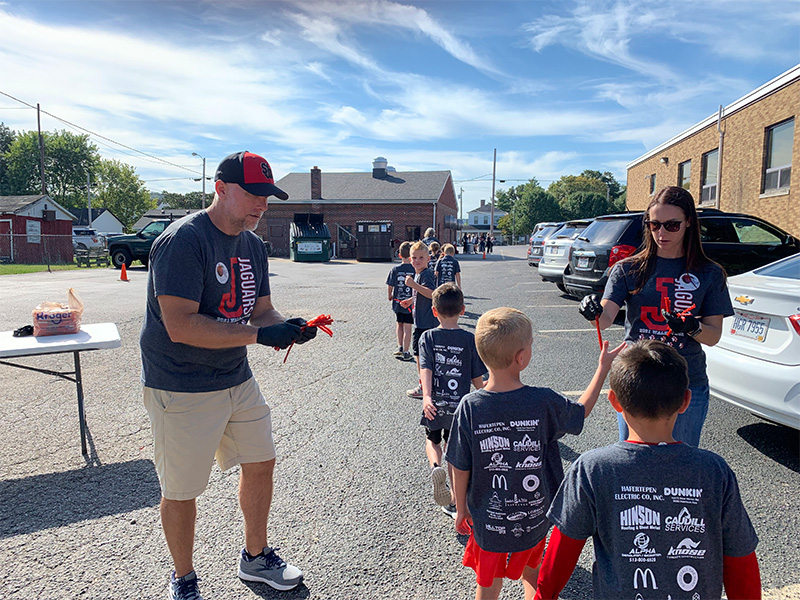 Community Involvement - Handing Out Treats to Line of Children