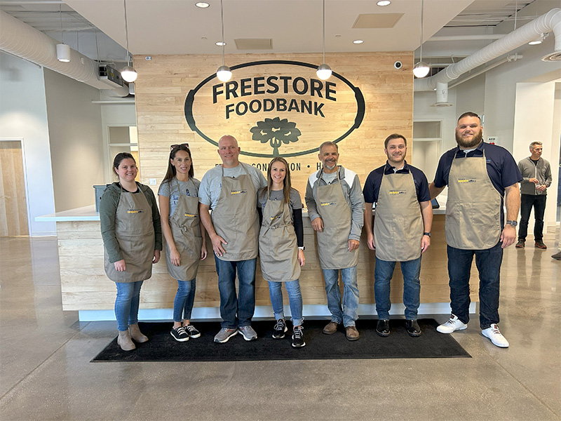 Community Involvement - Lauber and Will Team Group Photo in Lobby for Freestore Food Bank